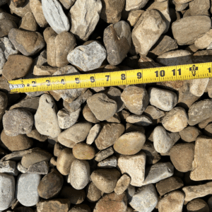 River rock of various sizes with a brown tone because of sediment
