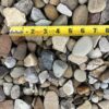 multicolored and shapes rocks, a ruler showing pieces around an inch or two