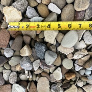 multicolored and shapes rocks, a ruler showing pieces around an inch or two