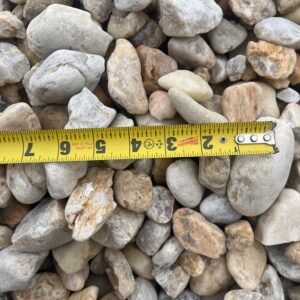 stone varying from greys to oranges and some brown, sizes ranging from around an inch to multiple inches