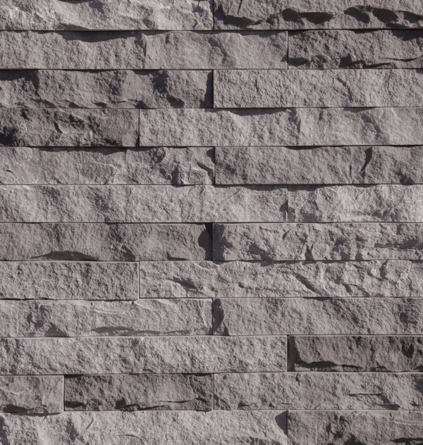 Grey stone with a natural stone surface but uniform sized with sharp corners and flat sides.