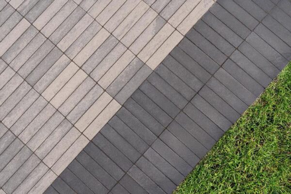 greyish tan thin pavers surrounded by two columans of darker grey ones