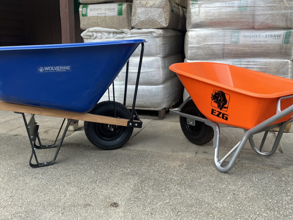 Two wheelbarrows, a larger blue one and a smaller orange one